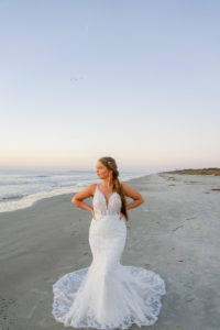 beaded lace fitted wedding dress on beach at sunrise