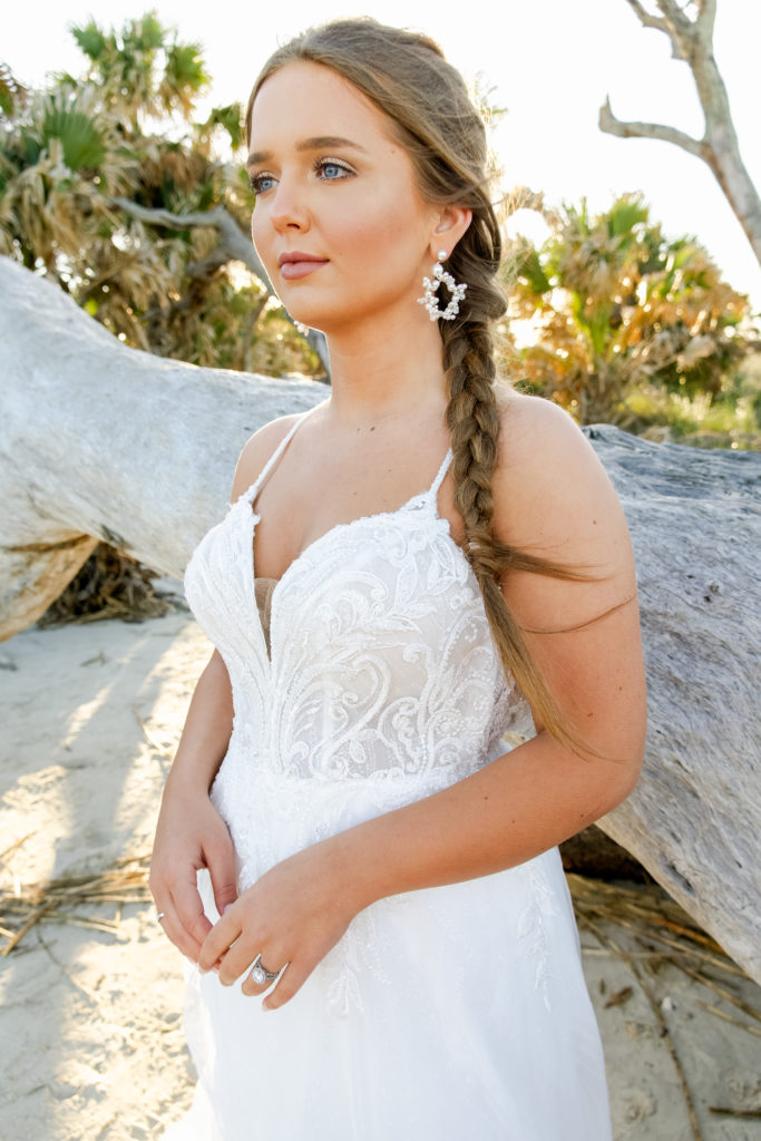 close up of beaded lace and tulle wedding dress at driftwood beach