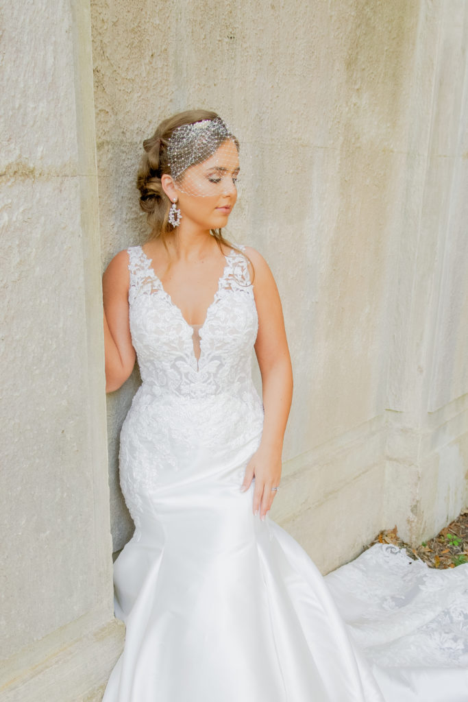 classic lace bodice mermaid wedding dress with bridcage veil and pearl earrings