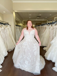 Plus size bride wears a full lace aline wedding dress with spaghetti straps and sparkle throughout