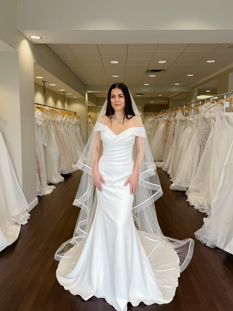 Fitted ruched crepe wedding dress with off the shoulder straps